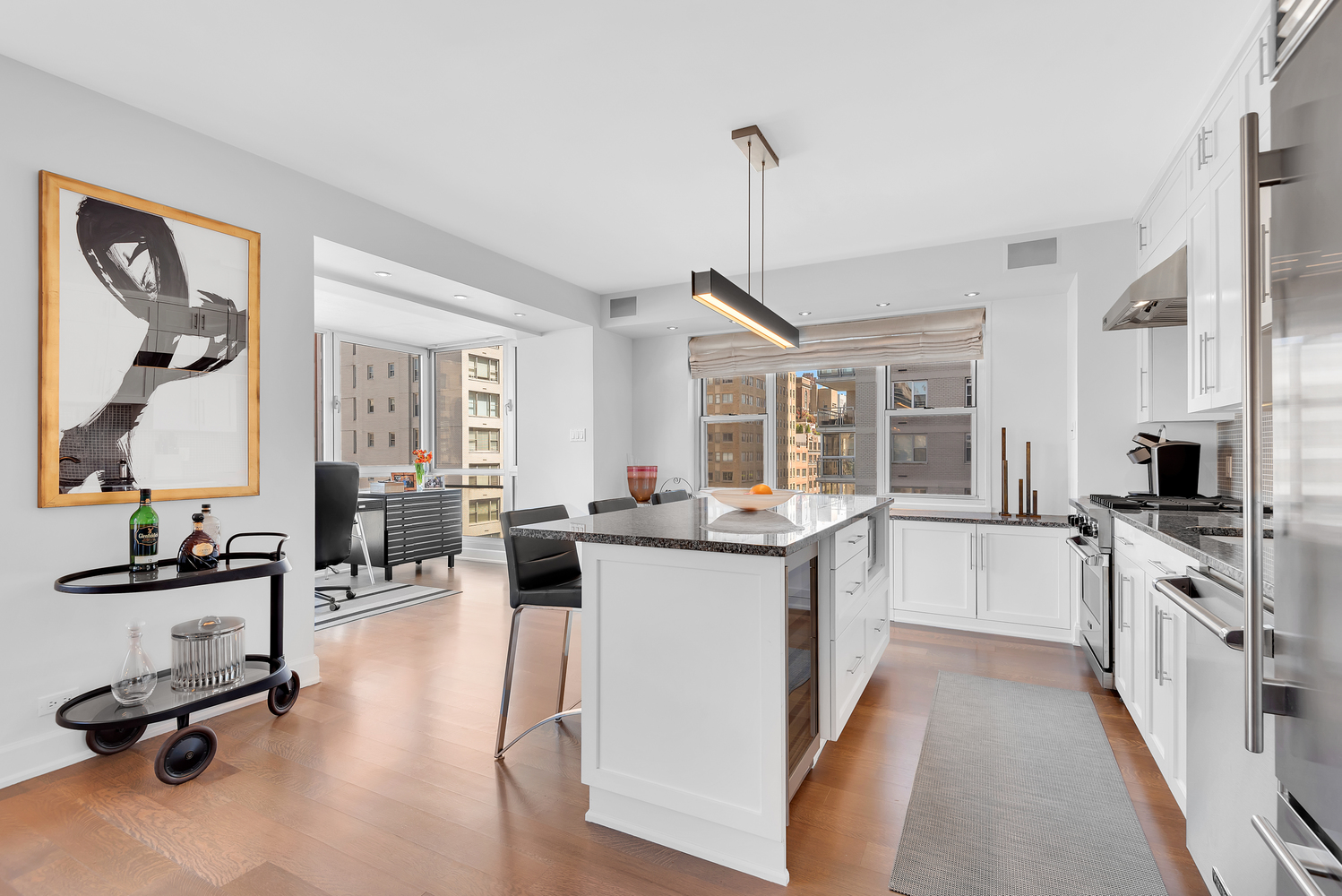 150 East 69th Street, Unit 8J Manhattan, NY 10021 - Photo 3 of 13 a kitchen with sink stove and cabinets