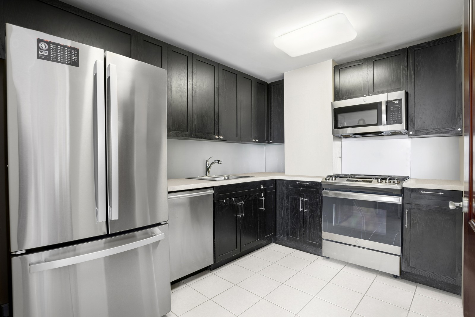 145 Park Place, Unit 4E Brooklyn, NY 11217 - Photo 5 of 15 a kitchen with stainless steel appliances granite countertop a refrigerator and a sink
