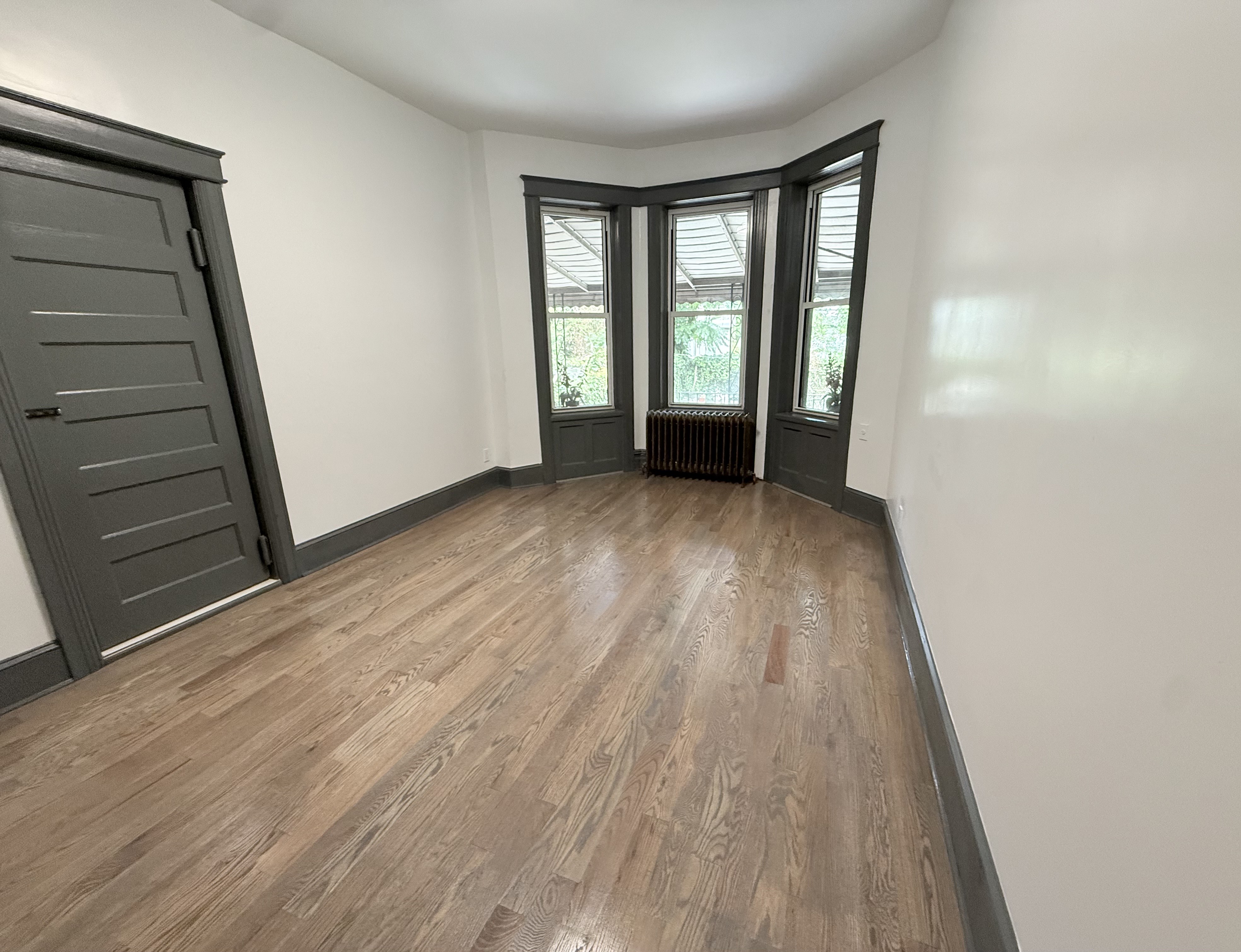 1191 Lincoln Place, Unit 1 Brooklyn, NY 11213 - Photo 6 of 13 wooden floor in an empty room with a window