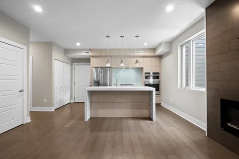 a view of kitchen with wooden floor and electronic appliances