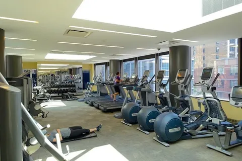 a room with gym equipment and a large window