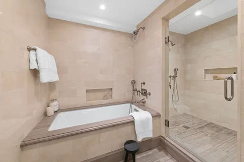 a bathroom with a tub and a shower