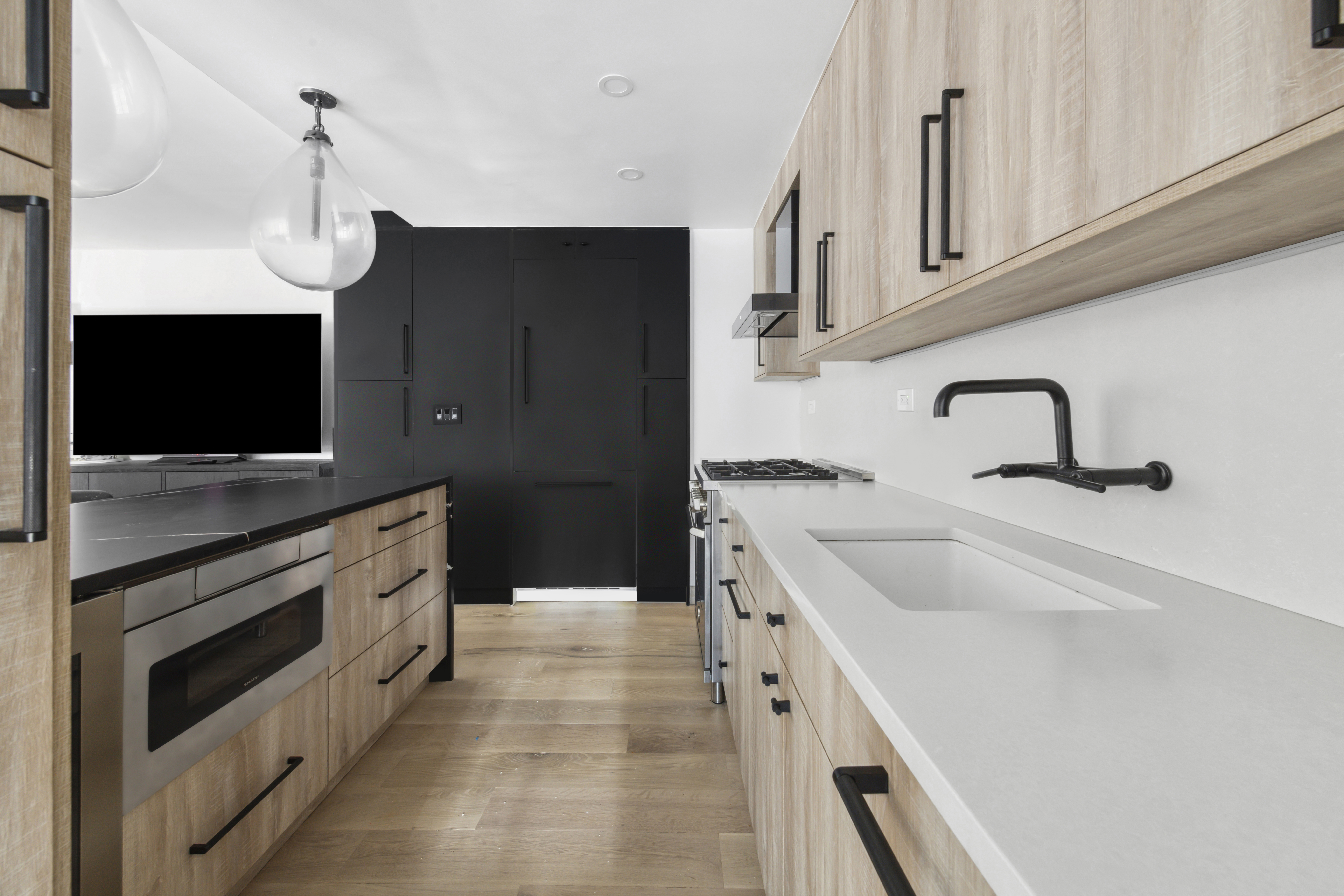 225 East 57th Street, Unit 14E Manhattan, NY 10022 - Photo 5 of 10 a kitchen with a sink and a stove top oven