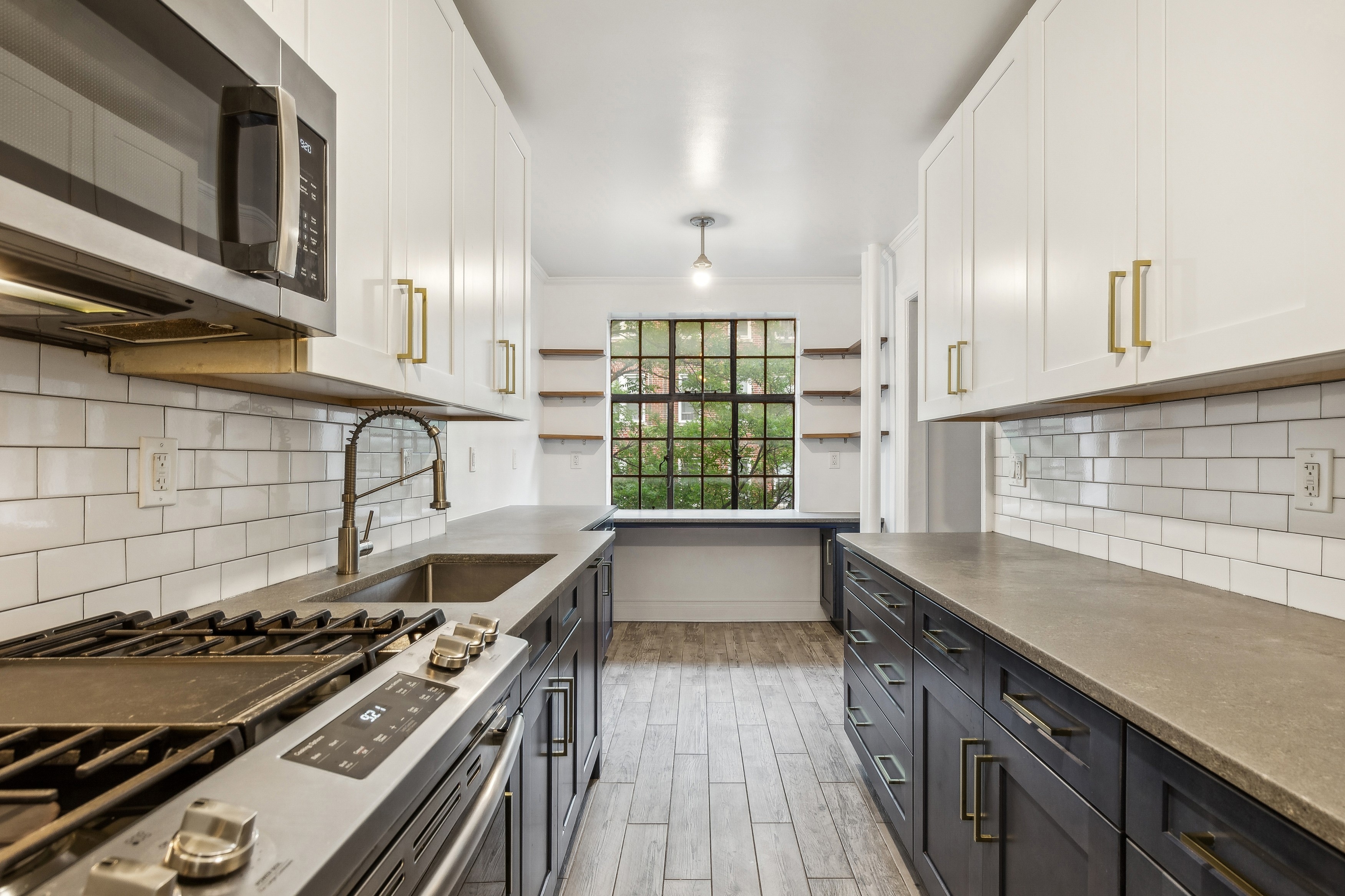 116 Pinehurst Avenue, Unit H32 Manhattan, NY 10033 - Photo 8 of 21 a kitchen with a stove and a wooden cabinets