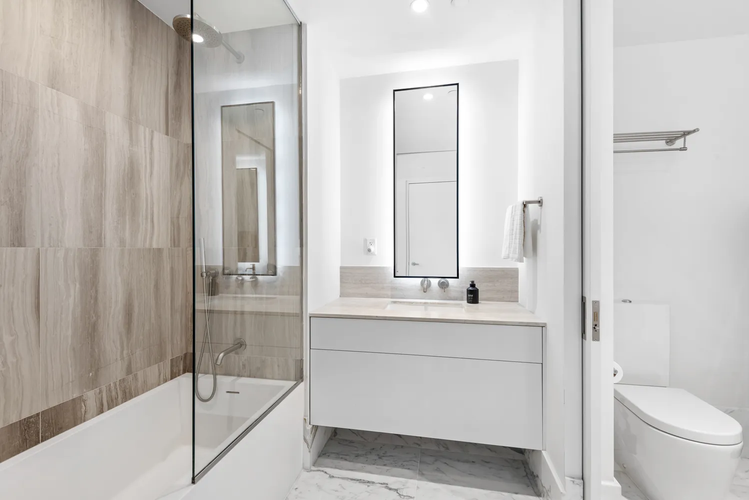 a bathroom with a sink a toilet and shower