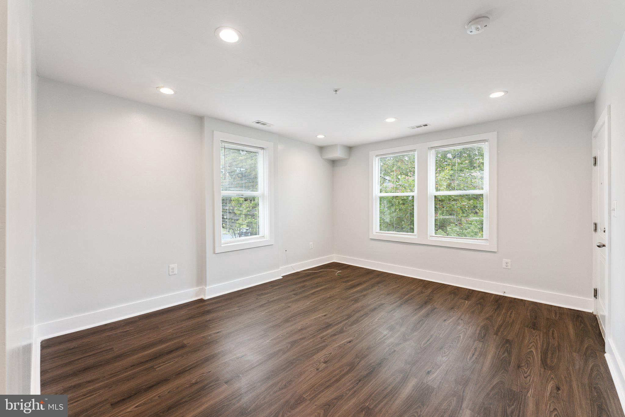 2822 28th Street Southeast Washington, DC 20020 - Photo 11 of 57 an empty room with wooden floor and windows