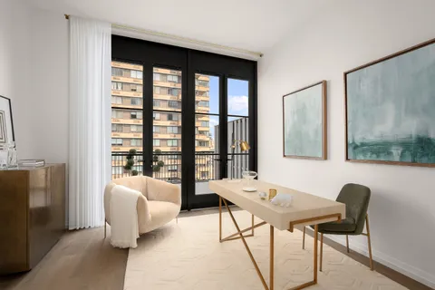 a living room with furniture and a floor to ceiling window
