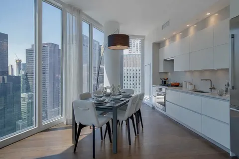a kitchen with furniture and wooden floor