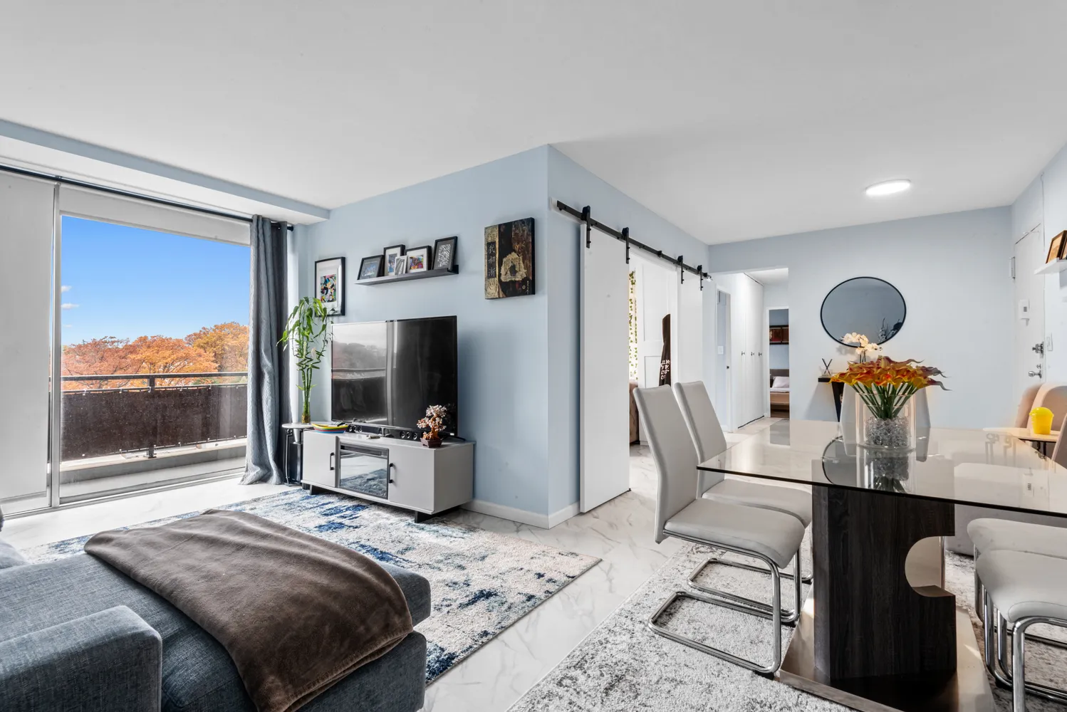 a bedroom with furniture and a large window