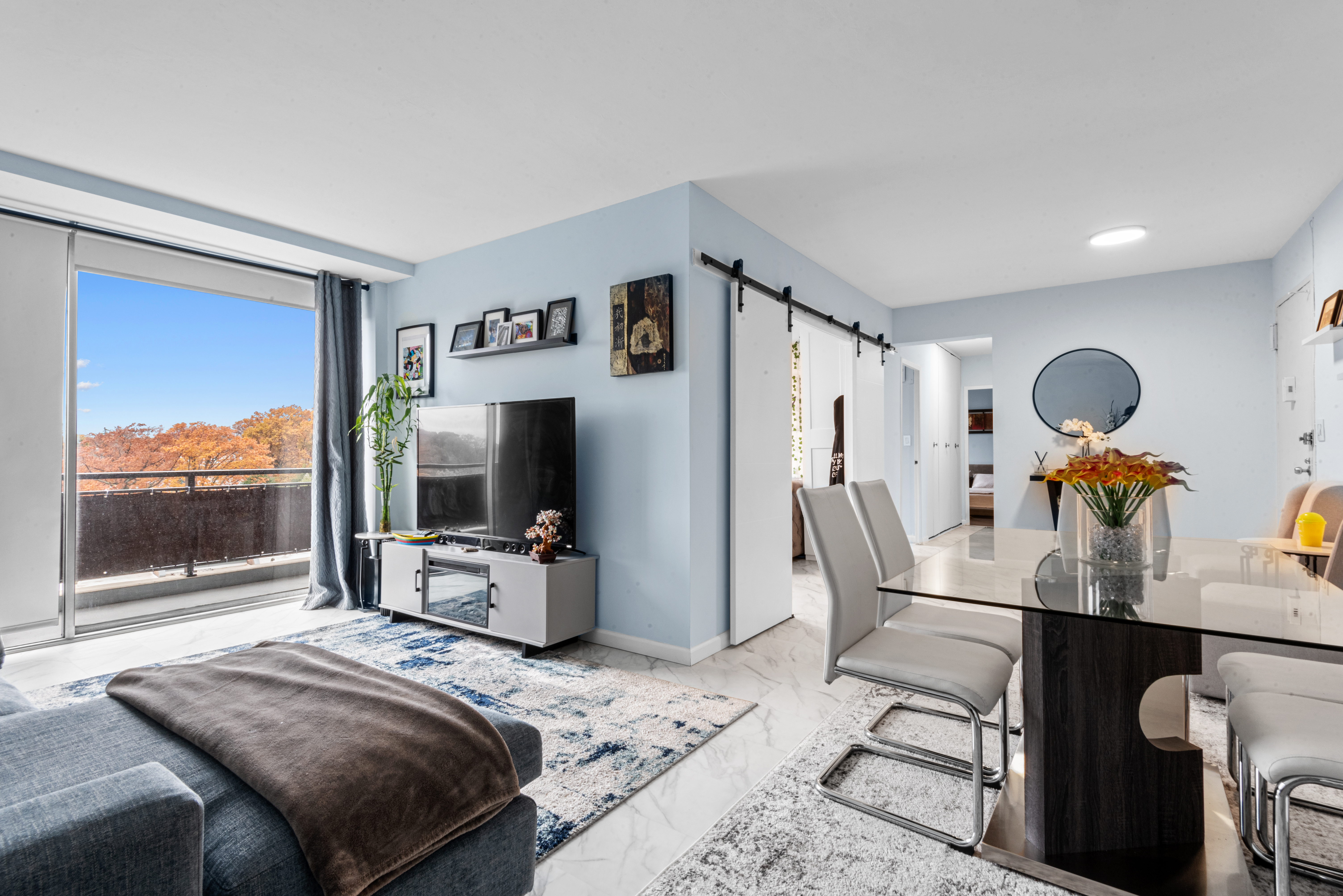 a bedroom with furniture and a large window