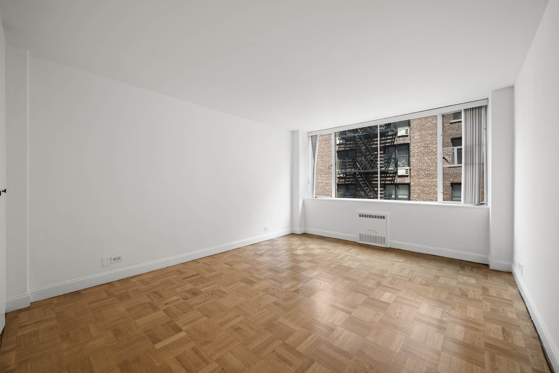 333 East 69th Street, Unit 3A Manhattan, NY 10021 - Photo 8 of 13 a view of an empty room with a window