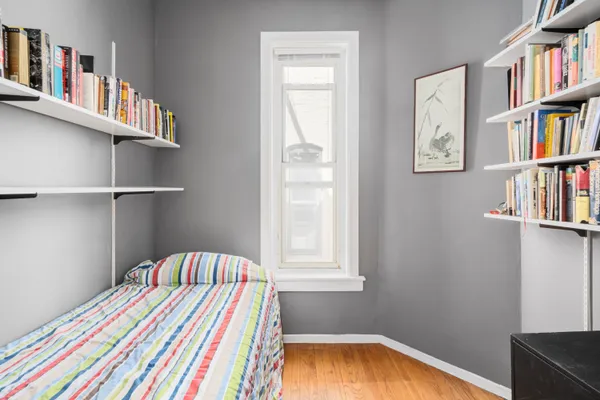 a bedroom with a bed and a book shelf
