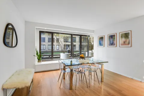 a living room with furniture a wooden floor and a window