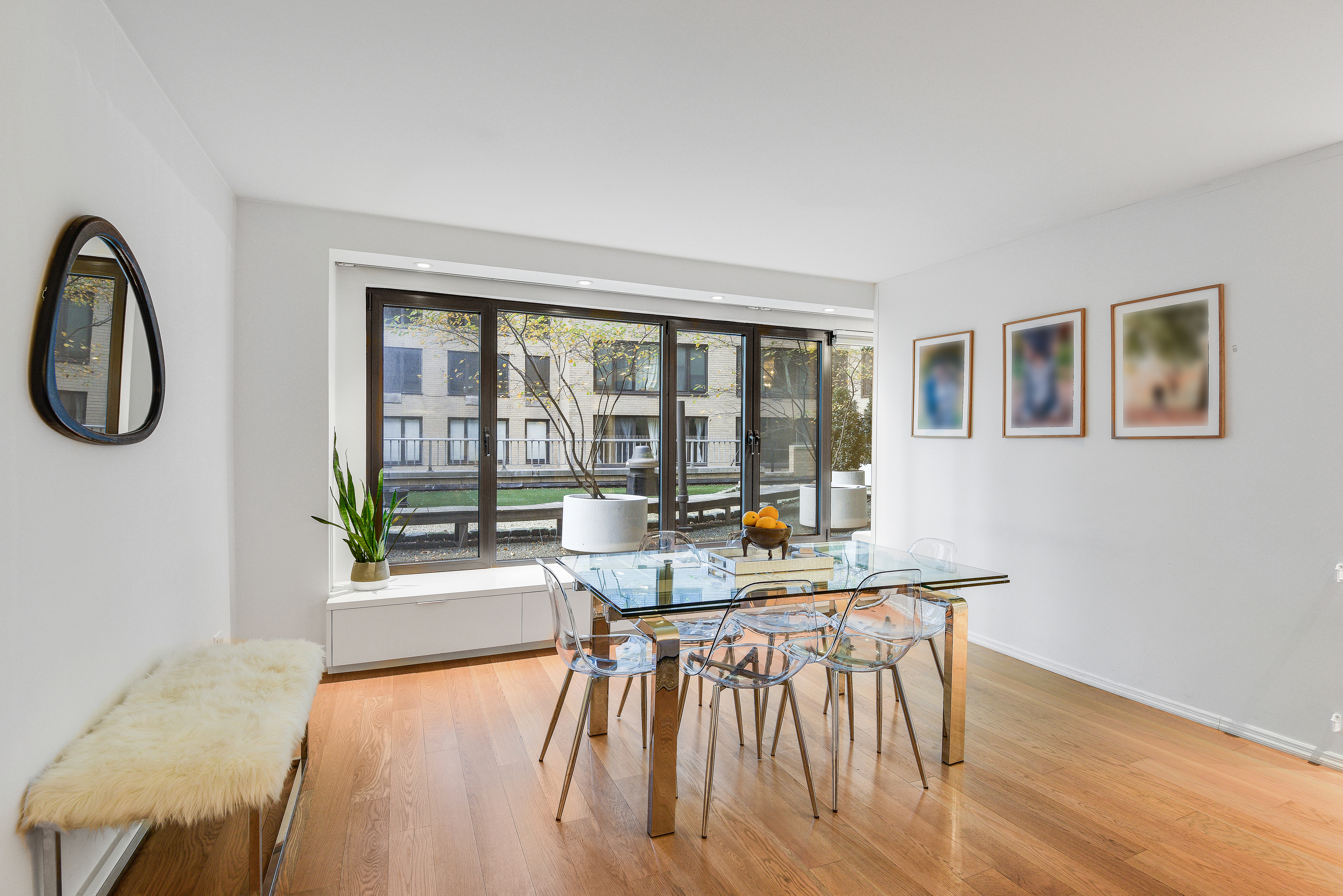 200 Central Park South, Unit 3Q Manhattan, NY 10019 - Photo 4 of 15 a living room with furniture a wooden floor and a window