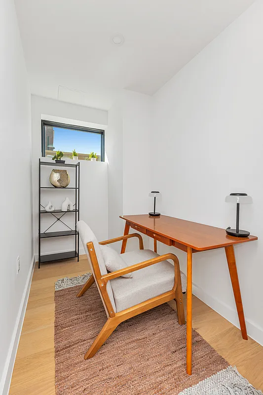 21-10 31st Avenue, Unit 6R Queens, NY 11106 - Photo 11 of 17 a bedroom with furniture and a rug