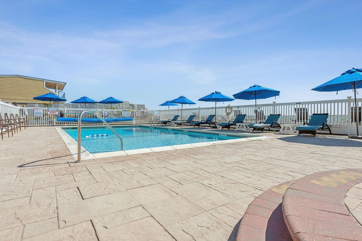 a view of a chairs and table on the roof deck