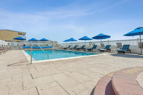 a view of a chairs and table on the roof deck