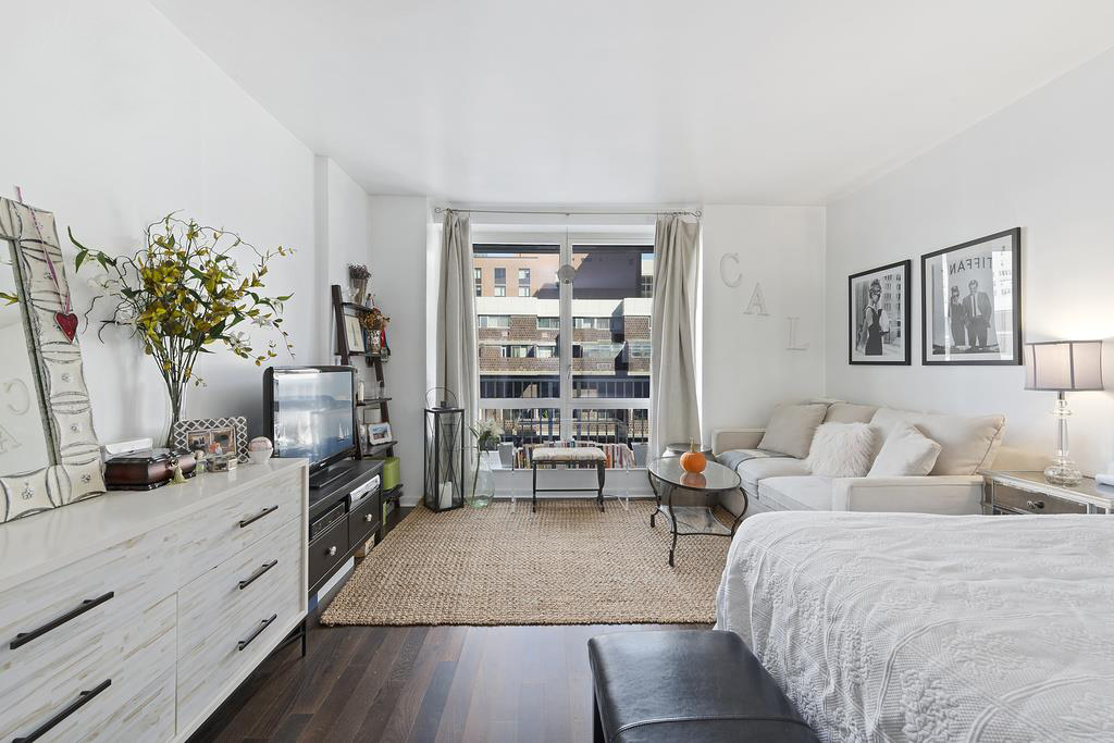 340 East 23rd Street, Unit 9J Manhattan, NY 10010 - Photo 1 of 5 a living room with furniture and a large window
