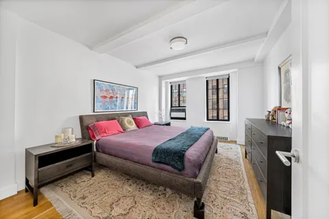 a spacious bedroom with a bed and a couch