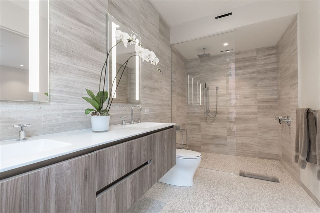 a bathroom with a sink a mirror and shower