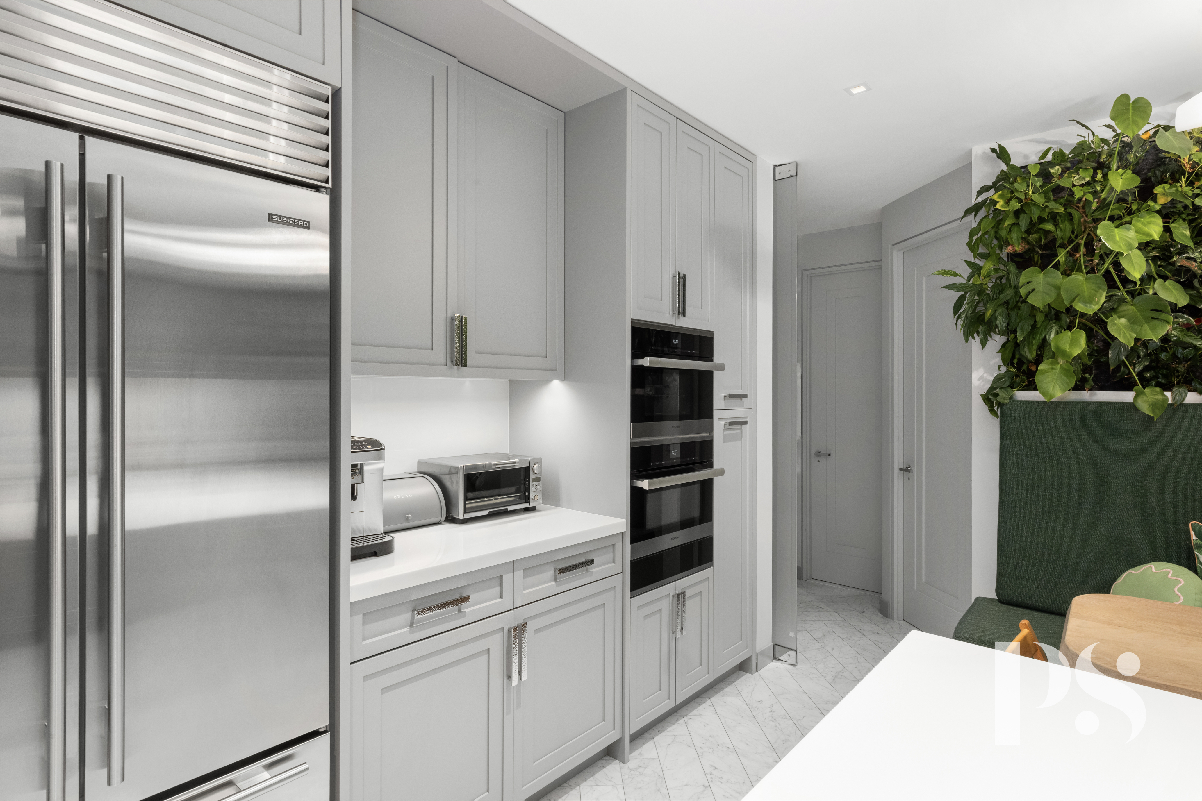 733 Park Avenue, Unit 4 Manhattan, NY 10021 - Photo 12 of 29 a kitchen with white cabinets and refrigerator