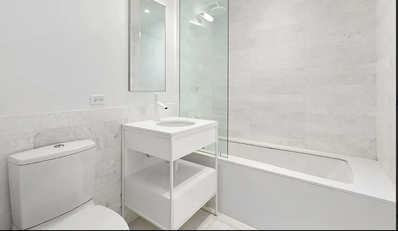 241 5th Avenue, Unit 13C Manhattan, NY 10016 - Photo 4 of 9 a bathroom with a sink a toilet and shower