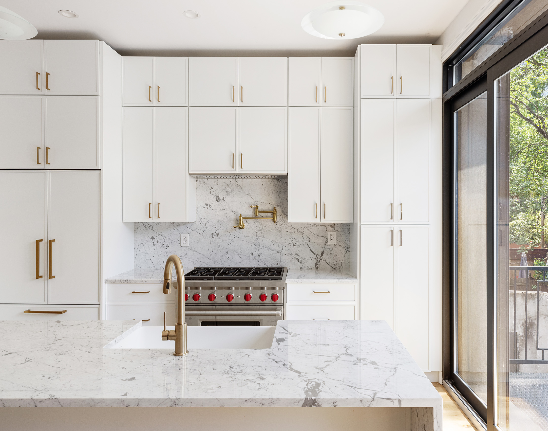 698 Macon Street Brooklyn, NY 11233 - Photo 5 of 17 a kitchen with stainless steel appliances granite countertop a refrigerator a stove a sink and white cabinets with wooden floor