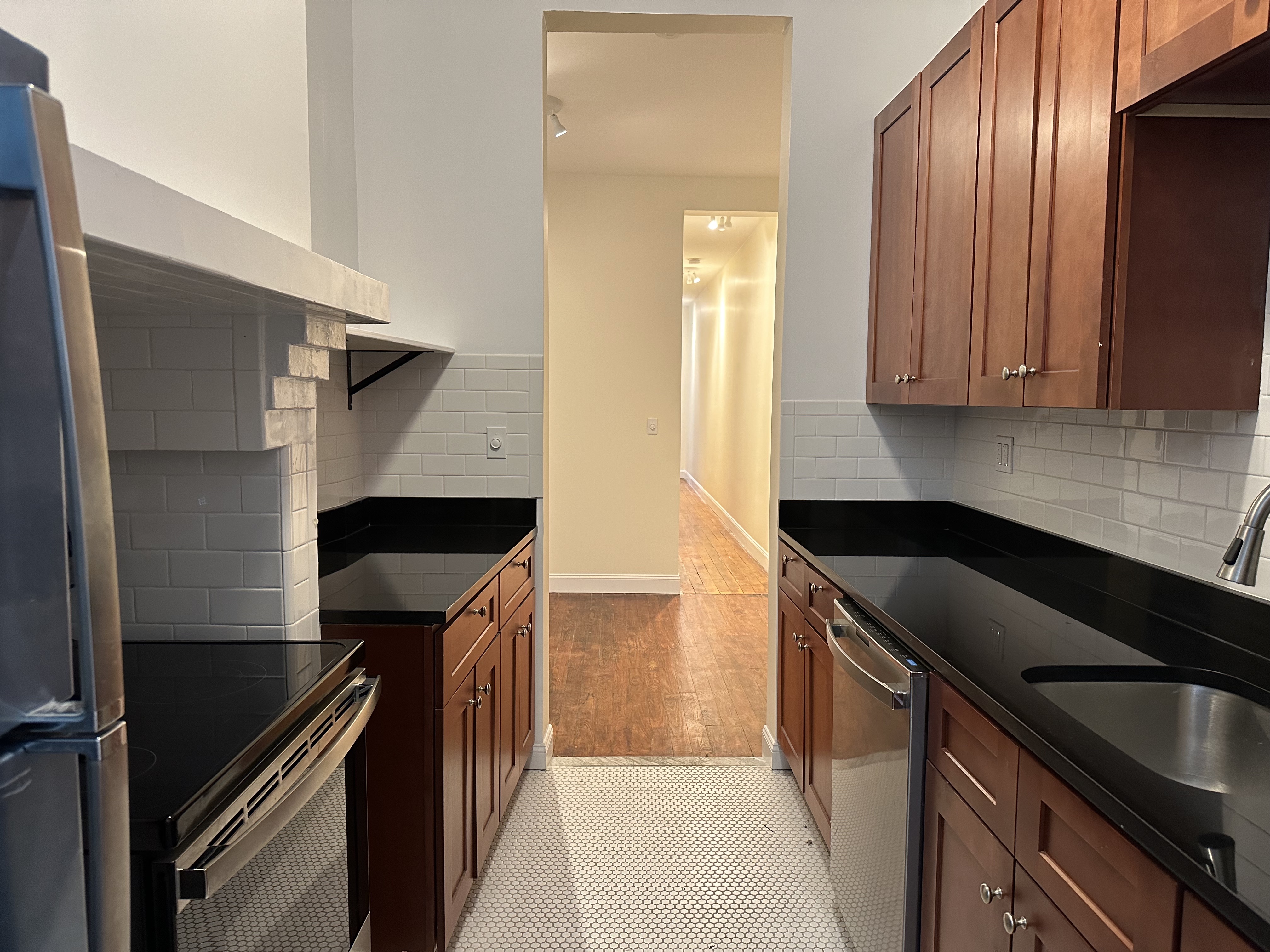 459 West 35th Street, Unit 1E Manhattan, NY 10001 - Photo 15 of 18 a kitchen with a sink and cabinets
