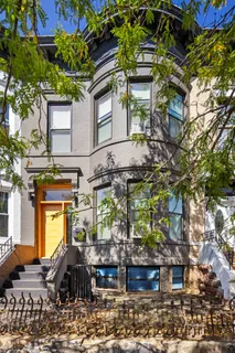 a front view of a houses with yard