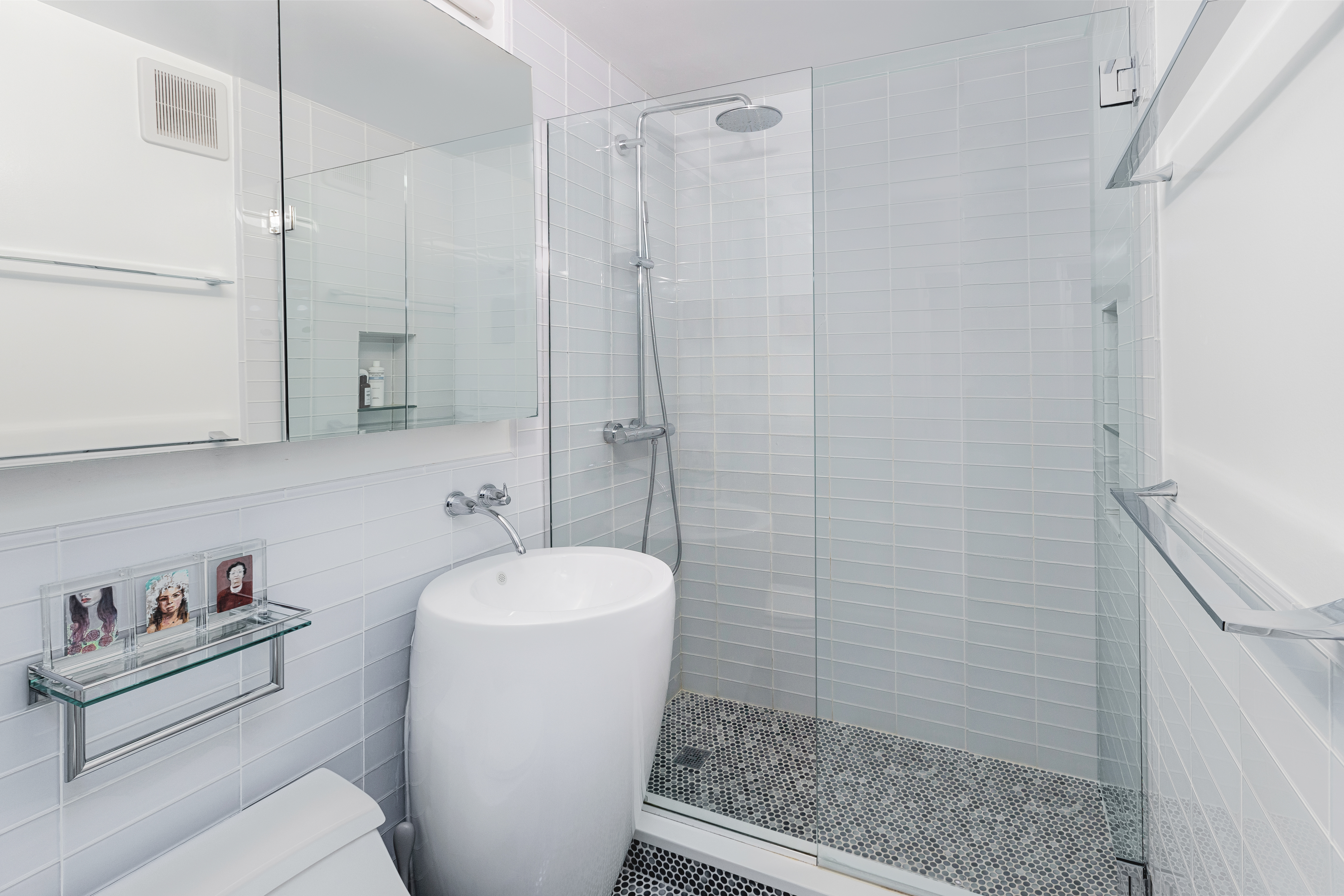 130 West 67th Street, Unit 2E Manhattan, NY 10023 - Photo 5 of 11 a bathroom with a sink a toilet and shower