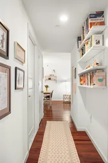 a hallway with a dining table and chairs