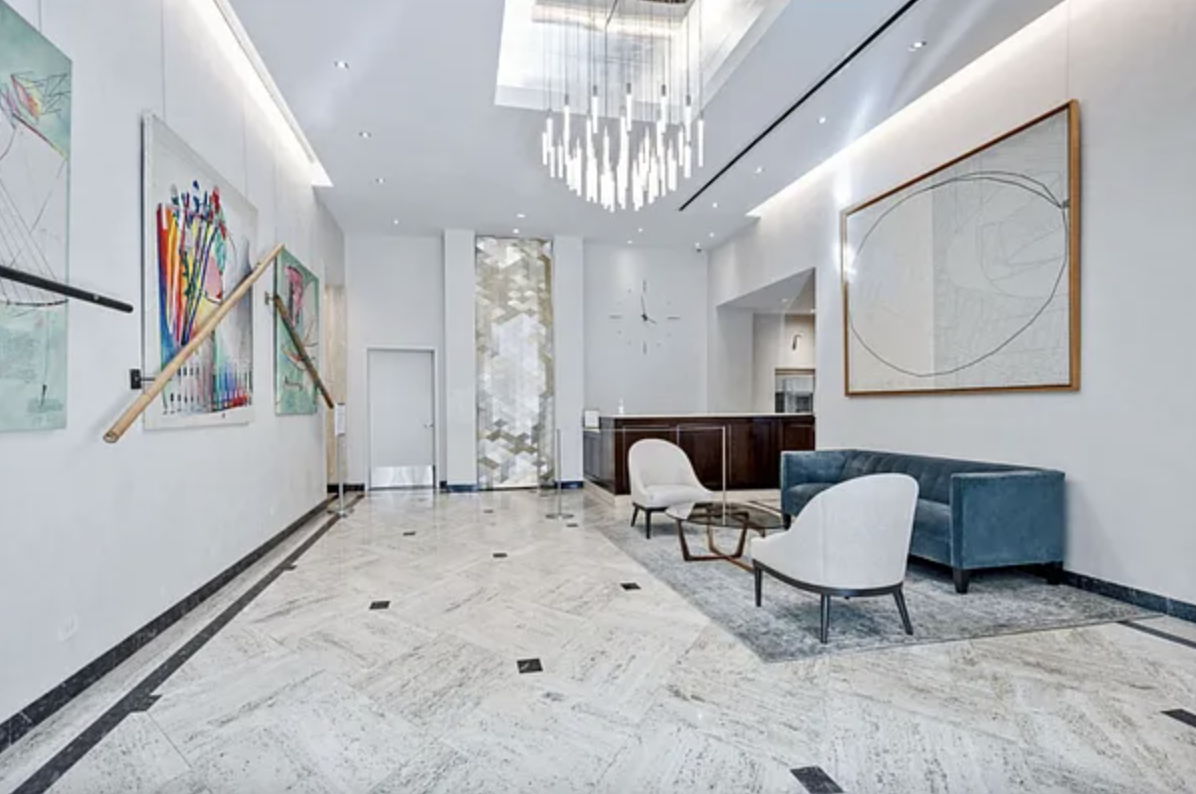 159 West 53rd Street, Unit 36C Manhattan, NY 10019 - Photo 7 of 9 a living room with furniture and a chandelier