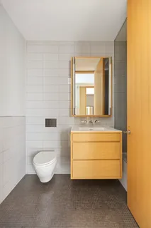 a bathroom with a sink a toilet and mirror