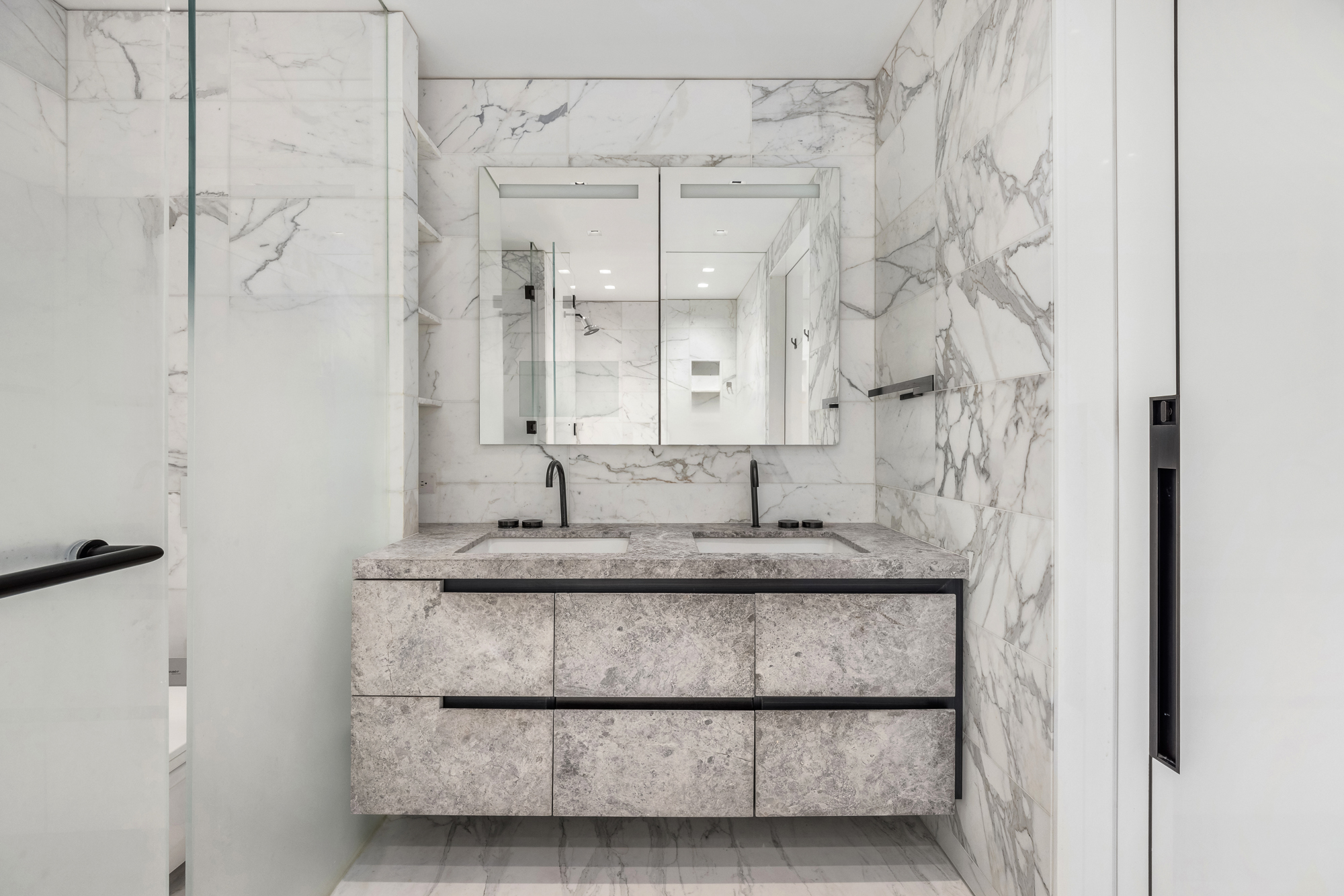 301 West 57th Street, Unit 36C Manhattan, NY 10019 - Photo 22 of 27 a bathroom with a granite countertop shower a sink and a mirror