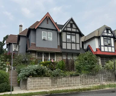 a front view of a house with a yard and potted plants