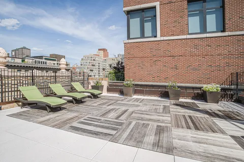 a view of roof deck with couch and outdoor seating