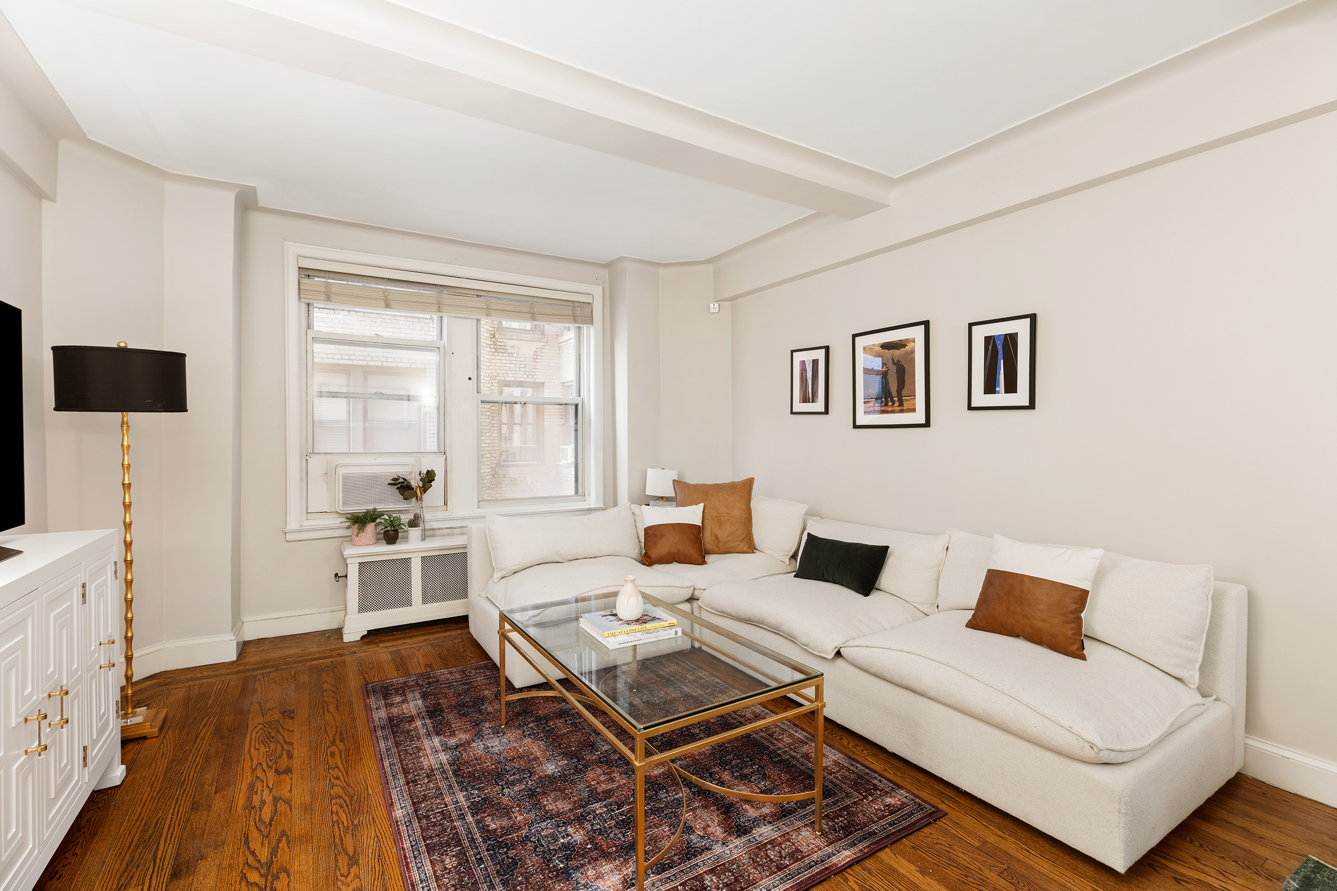 308 East 79th Street, Unit 4K Manhattan, NY 10075 - Photo 3 of 11 a living room with furniture and a flat screen tv