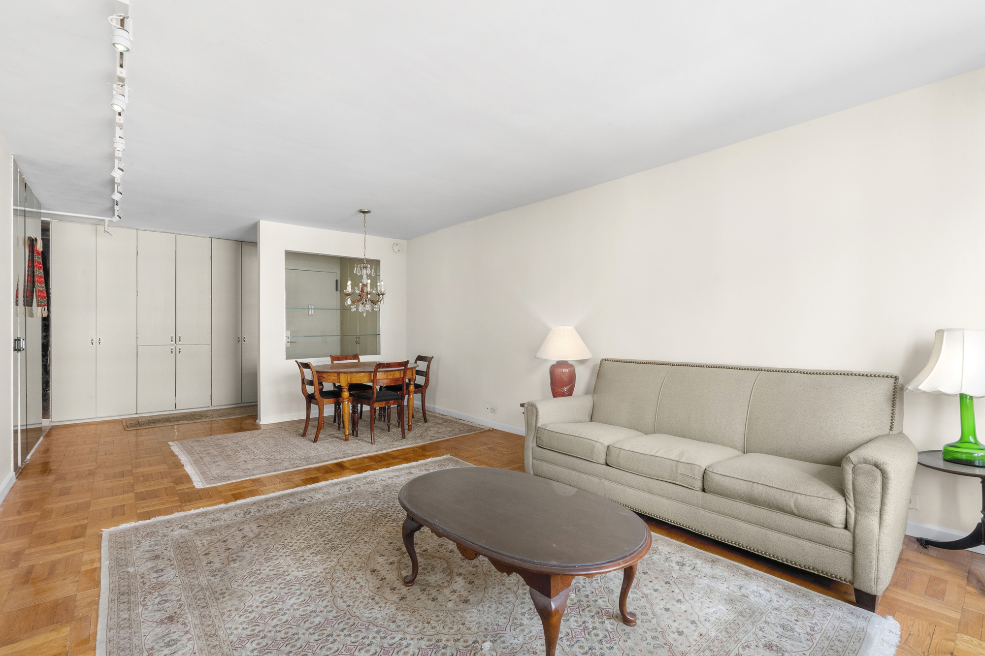 77 West 55th Street, Unit 16H Manhattan, NY 10019 - Photo 2 of 6 a living room with furniture and a table
