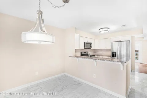 a kitchen with stainless steel appliances a refrigerator and a stove