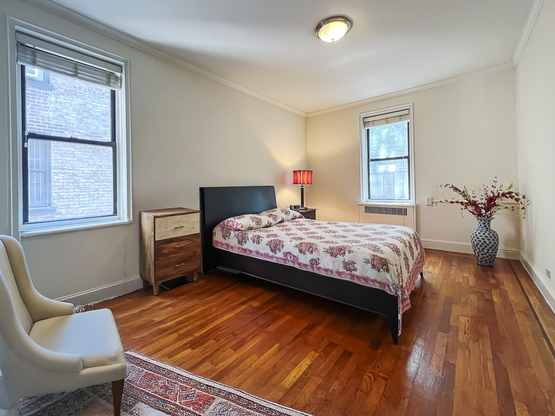 208 East 28th Street, Unit 4A Manhattan, NY 10016 - Photo 2 of 12 a bedroom with a bed and wooden floor