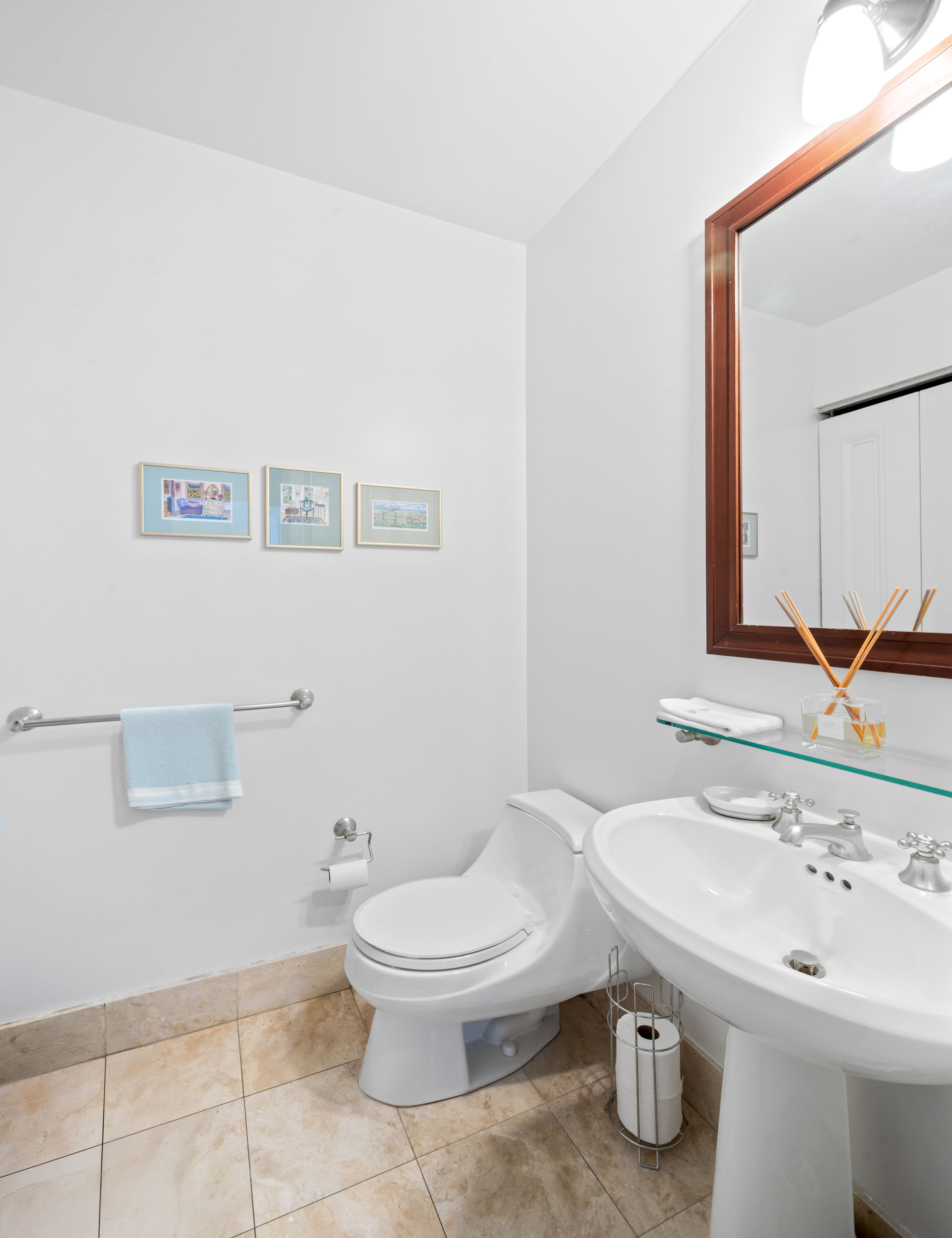 10 West Street, Unit 28C Manhattan, NY 10004 - Photo 10 of 12 a bathroom with a sink a toilet and mirror