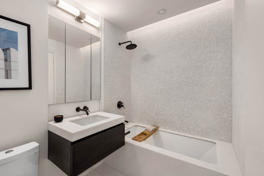 66 Clinton Street, Unit 4B Manhattan, NY 10002 - Photo 12 of 18 a bathroom with a sink and a tub