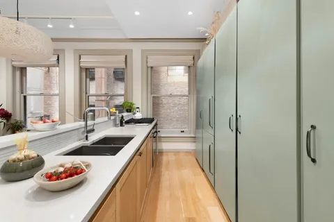 a kitchen with stainless steel appliances kitchen island granite countertop a sink and cabinets
