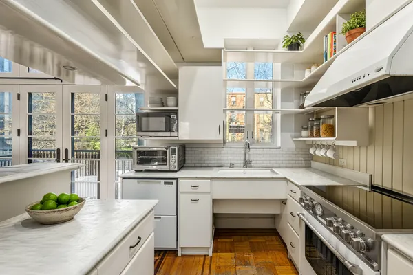 a kitchen with stainless steel appliances kitchen island granite countertop a stove and cabinets