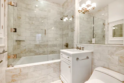 a bathroom with a sink mirror toilet and bathtub