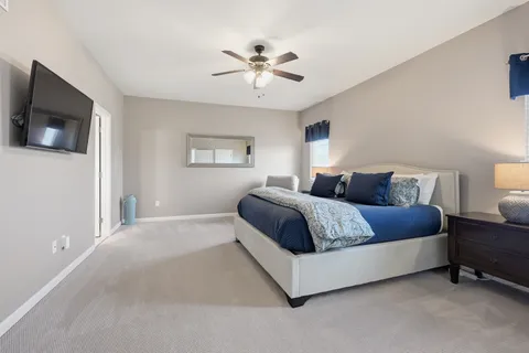 a spacious bathroom with a tub sink and mirror