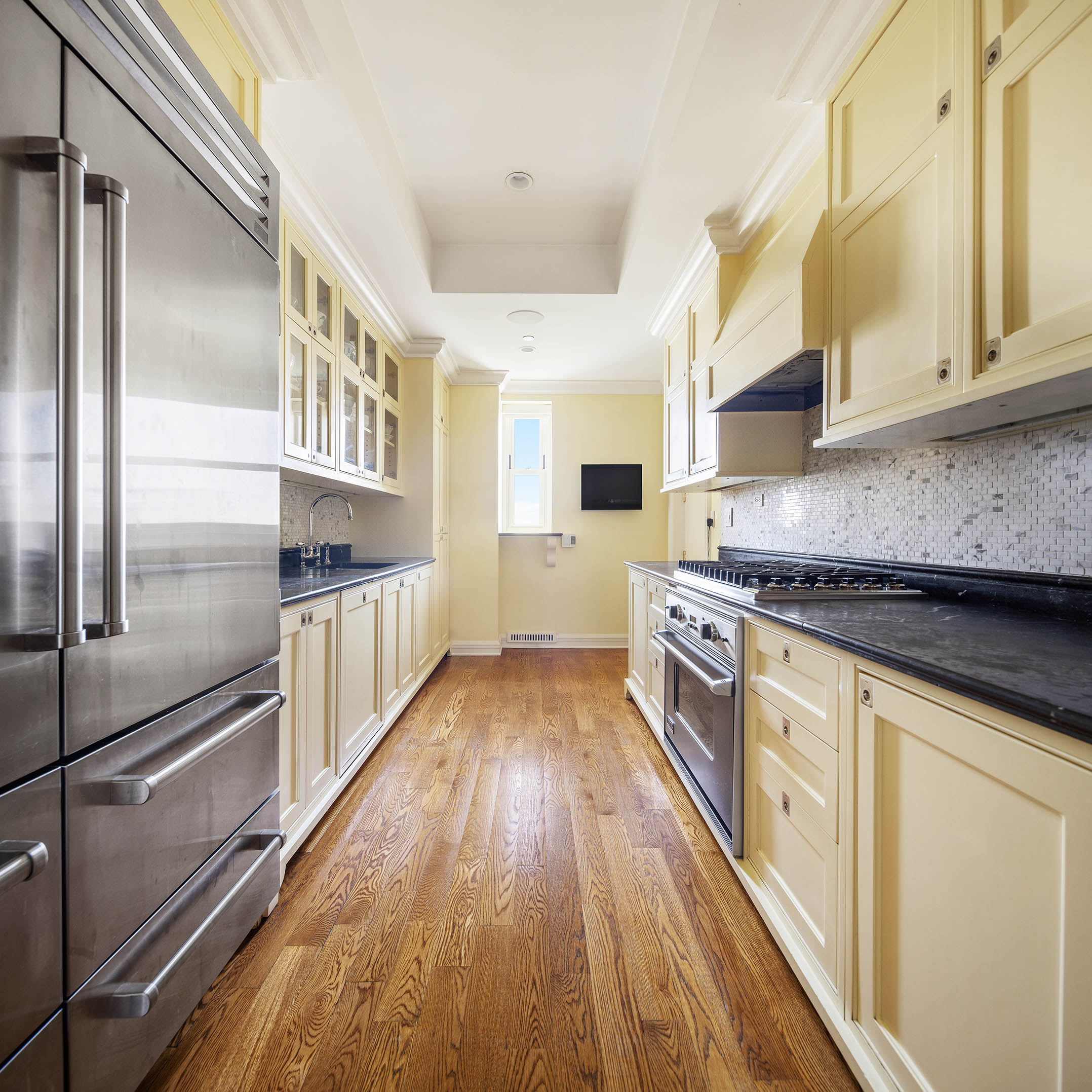 1 Central Park South, Unit 1309 Manhattan, NY 10019 - Photo 15 of 26 a kitchen with stainless steel appliances a refrigerator and a stove