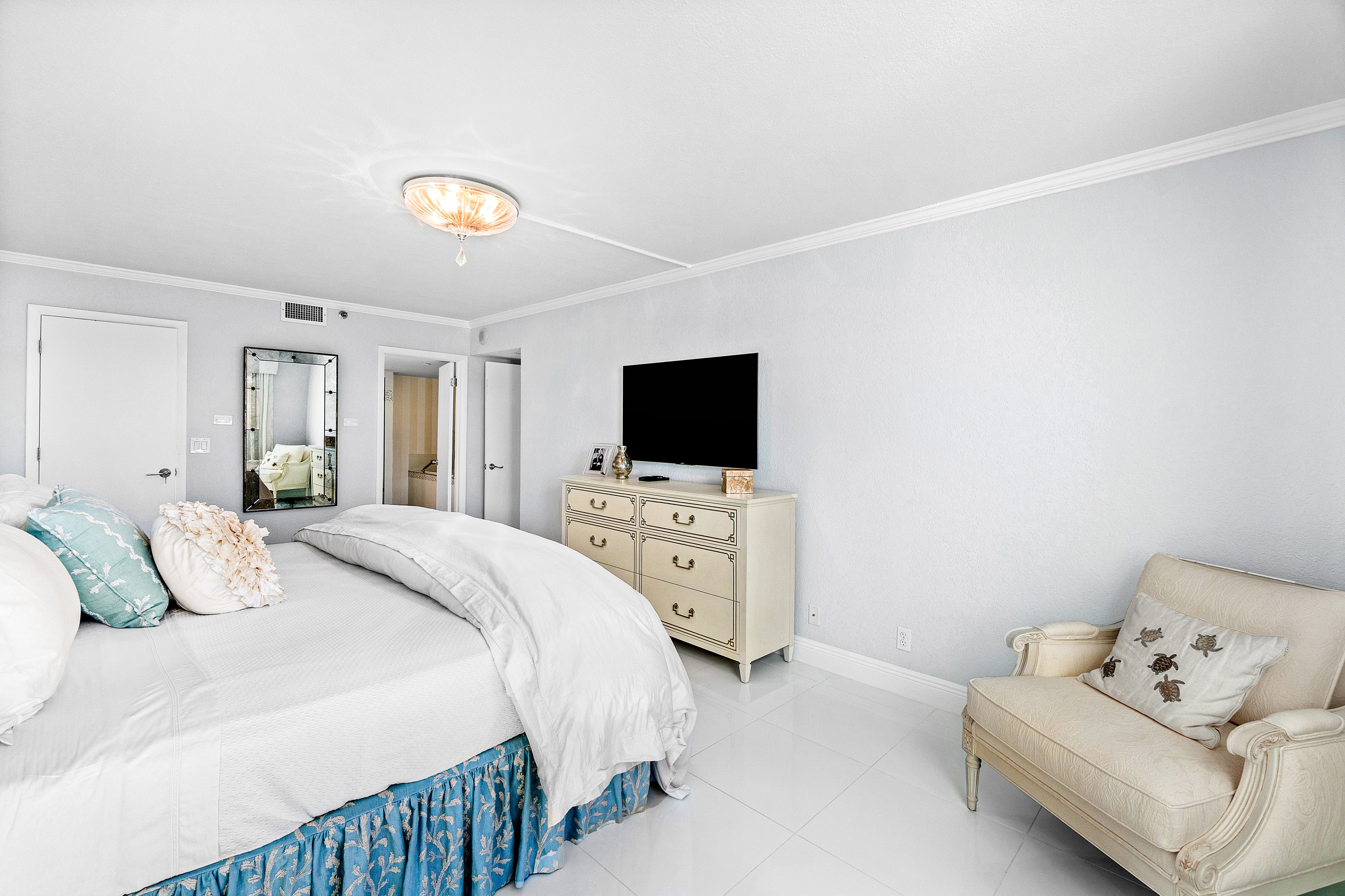 2003 North Ocean Boulevard, Unit 305 Boca Raton, FL 33431 - Photo 42 of 56 a bedroom with a bed and a flat screen tv