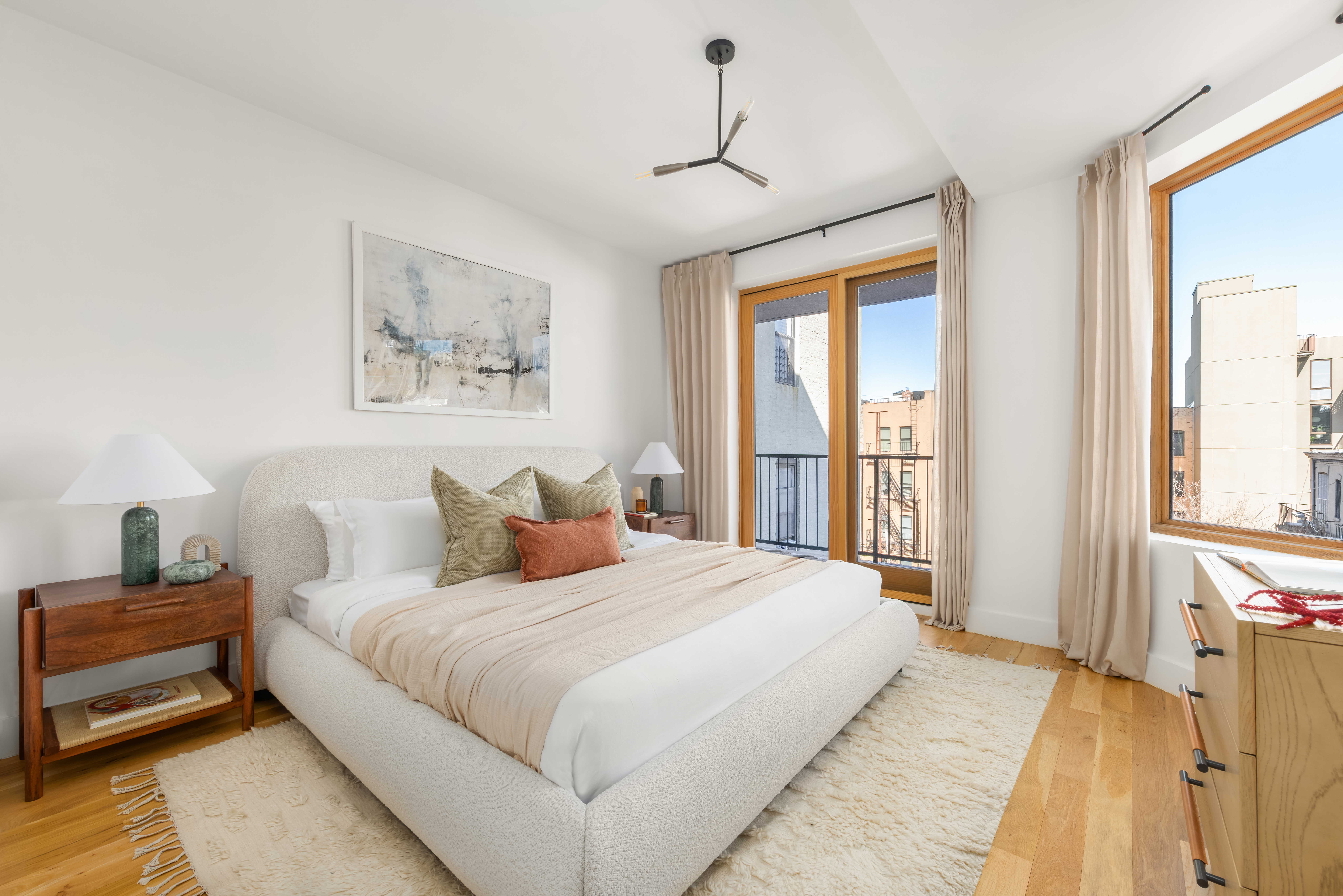 529 Park Place, Unit 401 Brooklyn, NY 11238 - Photo 4 of 13 a bedroom with a large bed and a window