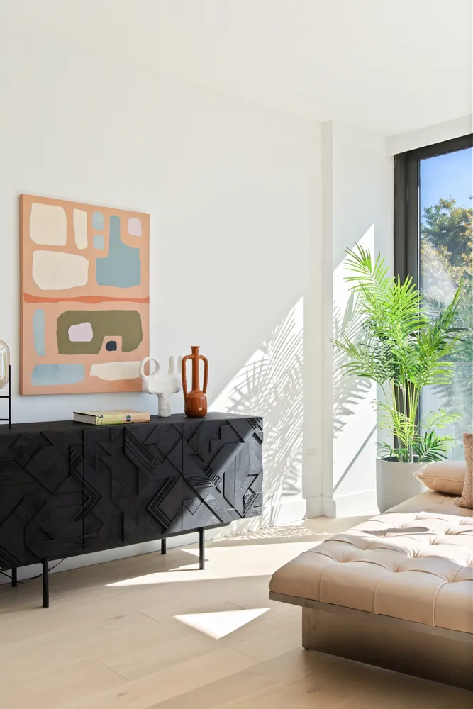 a living room with furniture and a potted plant